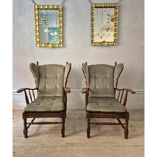 A pair of wingback chairs in oak, with soft green wool mix fabric. Country style, Scandinavian 1960/70s. In good...