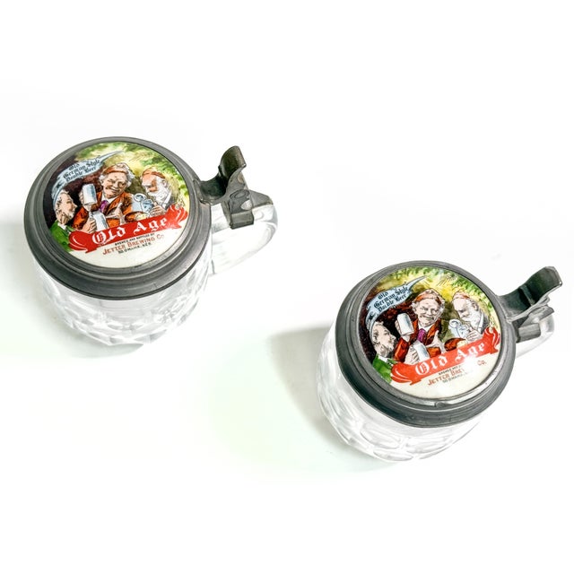 An exceptional pair of authentic pre-Prohibition advertising beer steins from Jetter Brewing Company of South Omaha,...