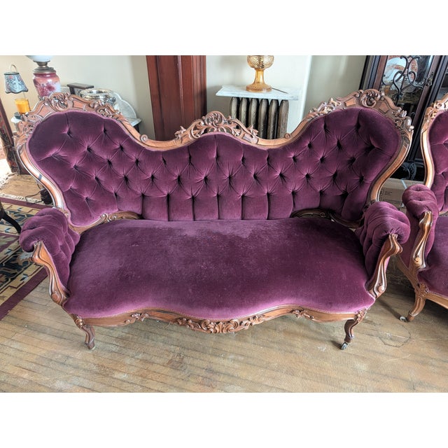 Matched pair of Victorian rococo revival sofas in a beautiful plum velvet. professionally restored and reupholstered. They...