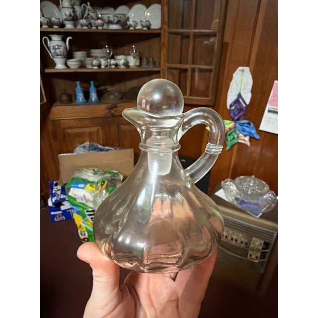 Vintage clear pressed glass cruet bottle with original glass stopper and side handle. Pieces like this were commonly used...