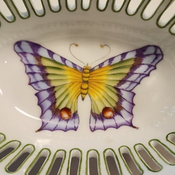 A stunning example of Hungarian artistry, this 5.25" oval pierced dish was hand-painted by artist Bacsó Éva for Anna...