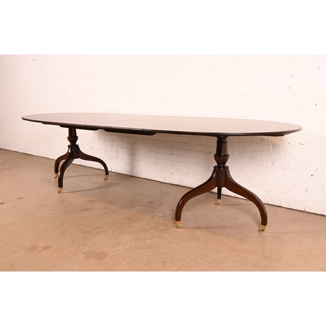 An exceptional Georgian or Regency style double pedestal extension dining table By Old Colony Furniture Co. USA, Circa...
