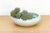 This low-profile ceramic vessel is a fine addition to an architectural tabletop collection, featuring a soft celadon-style...