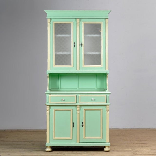 Large pine buffet cabinet from circa 1930 in its original paint. The cabinet consists of two separate sections. The upper...