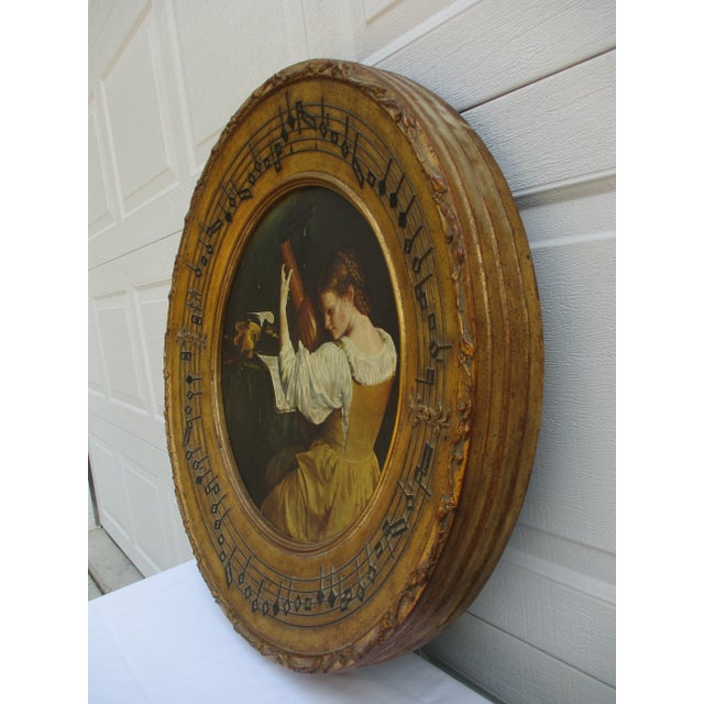 This massive 30-inch diameter gilded round picture frame features a reproduction print of a lute player after the work of...