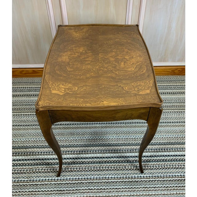 This set of two burl nesting tables were made by the Baker Furniture Co. in the 1960's. The burl tops are framed by...