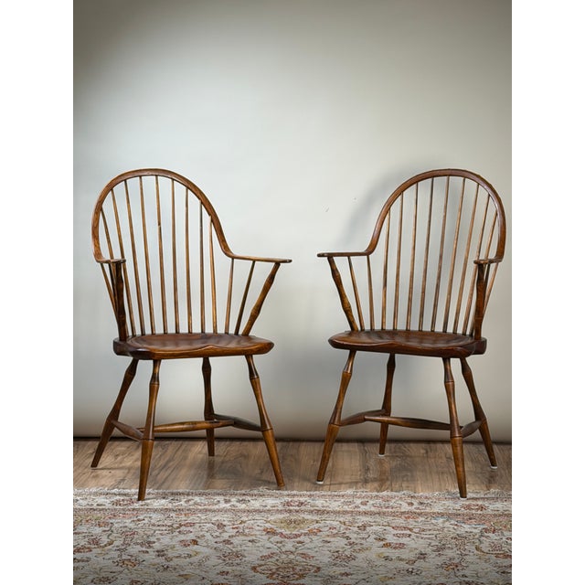 A handsome pair of signed L.E. Partridge Connecticut bench-made continuous-arm Windsor chairs dating to circa 1960s,...