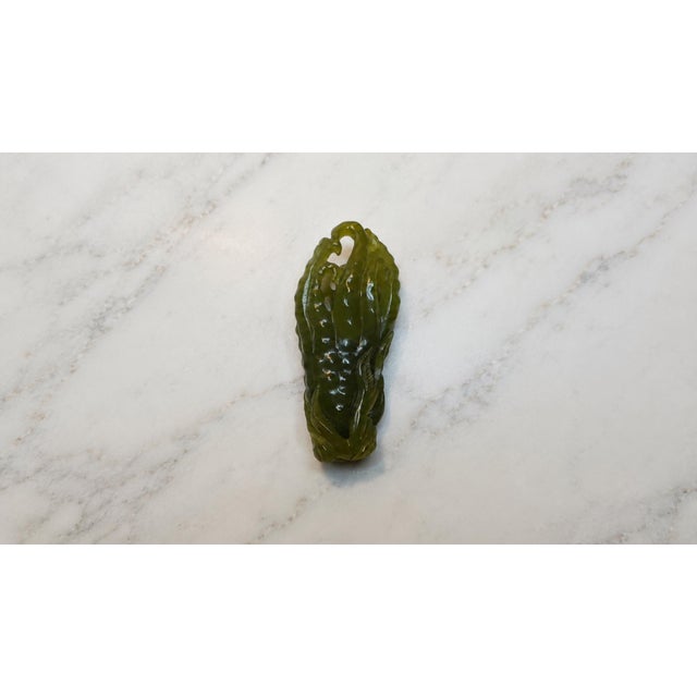 A finely carved Chinese nephrite jade scholar’s vessel in the form of the auspicious “Buddha’s Hand” citron (佛手), dating...