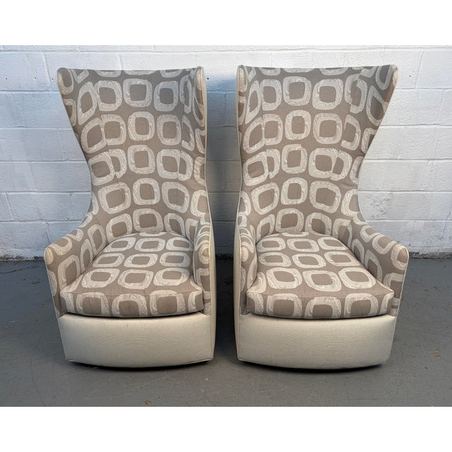 A sophisticated pair of high-back swivel wing chairs by Thayer Coggin, showcasing the brand’s renowned commitment to...