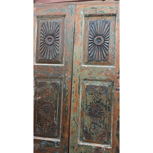 Elevate your home with the timeless beauty of this hand-carved floral wood barn door. Crafted from solid reclaimed wood,...