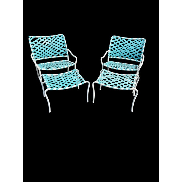 A coordinating four-piece vintage outdoor seating set by Tropitone, comprising two armchairs and two matching ottomans....