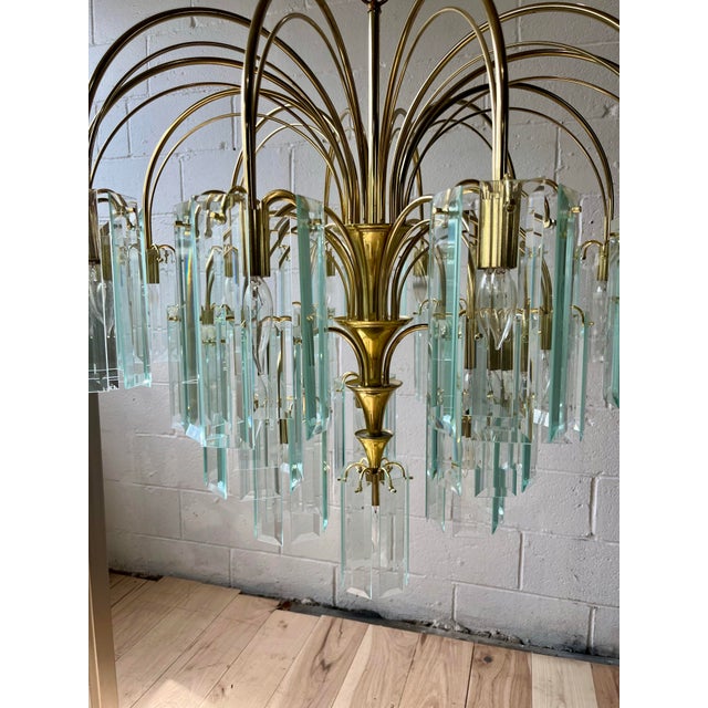 A spectacular monumental Italian Modernist chandelier dating to the 1970s, featuring an architectural polished-brass...