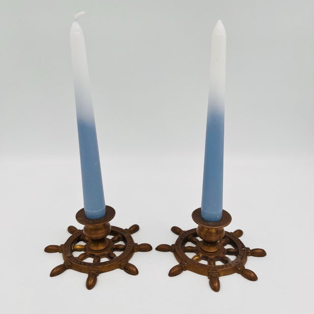 This charming pair of vintage brass candlestick holders features a nautical ship’s wheel design. Together, they weigh...