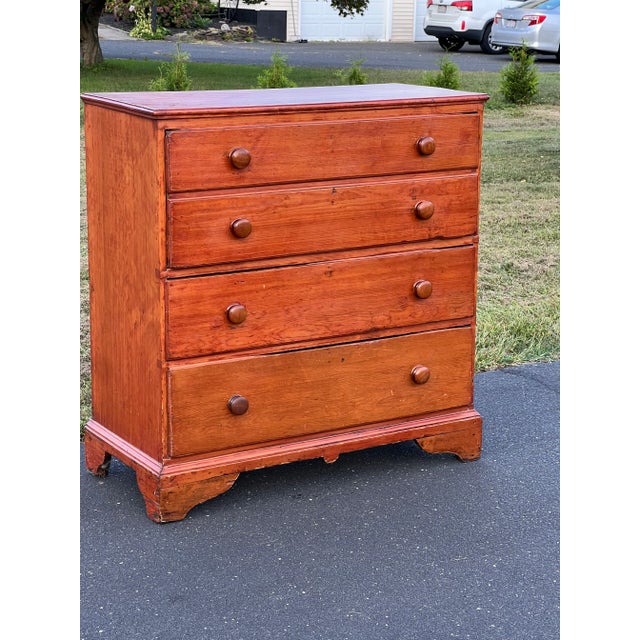 This Antique Pine Chippendale Chest, dated 1808 and perched on a classic bracket base, showcases the robust charm and...