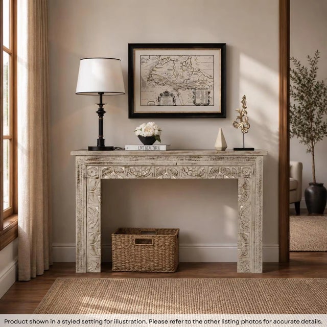 Dimensions: 47"wide X 16"deep X 30"high This hand carved console is finished in a greenish gray showing a distressed brown...