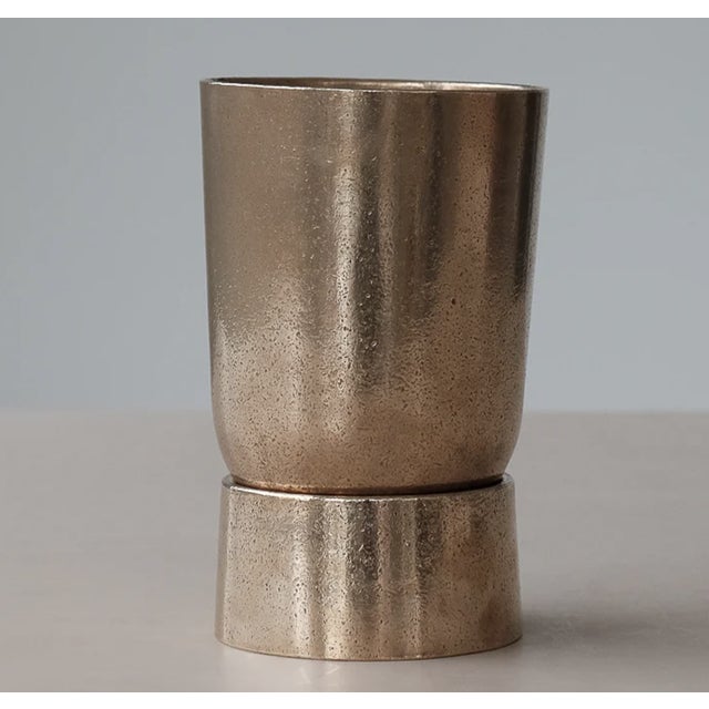 Substantial, architectural table lamp with cylindrical, rounded base and large, cup shaped shade. Articulated shade can be...