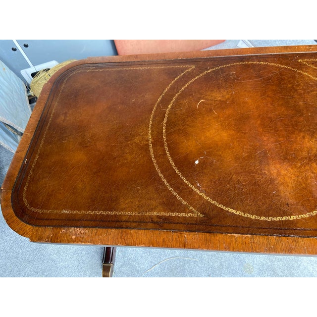 This Antique Leather Top Federal Style Mahogany Hollywood Regency Coffee Table is a stunning piece of furniture from the...