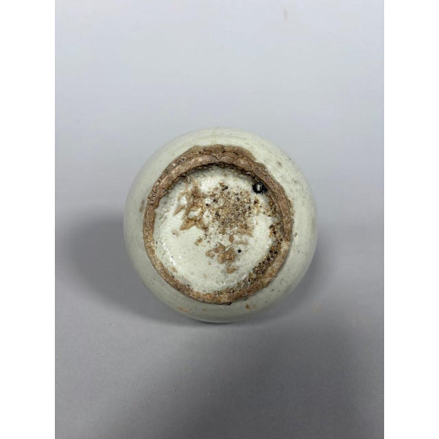 Porcelain vase, Joseon period, Korea, 18th century. Globular porcelain vase with a white slip finish. Small chip on the...