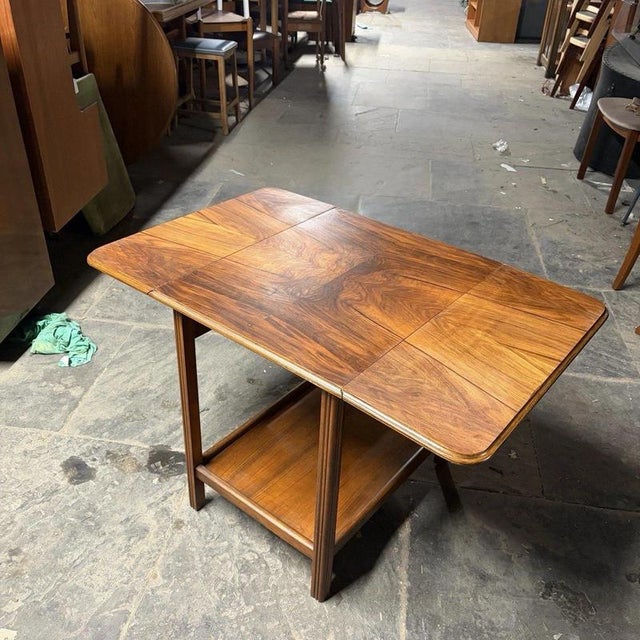 A beautifully figured 1960s drop-leaf coffee table with burr walnut veneer, contrasting oak construction and a practical...