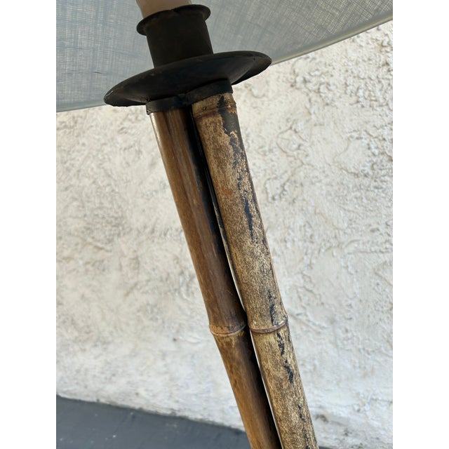 Stunning floor lamp made of weathered bamboo and black wrought iron. Includes beautiful Beige linen concave lampshade....
