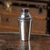 A 20th century english solid silver cocktail shaker with a polished, tapered round body. Inside the shaker, concealed...