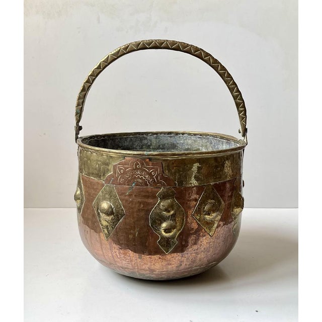 A Large Moroccan Moorish style polished brass and copper planter or fire bucket, handcrafted and chiseled with Moorish...