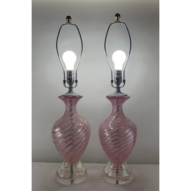 These beautiful Murano glass lamps add the perfect pop of color. Each stunning pink lamp has ribbed swirls with tiny...