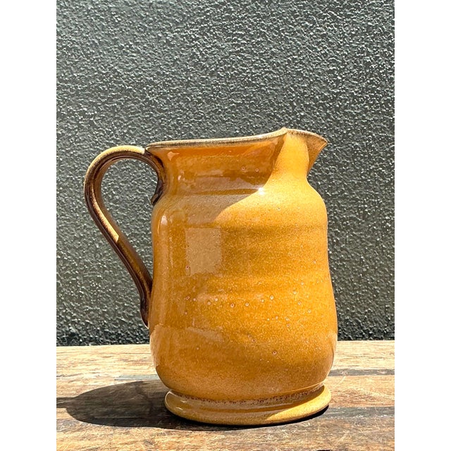 Embrace the rustic elegance of the Mediterranean with this stunning vintage Italian ceramic pitcher. Hand-crafted with a...
