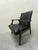 Understated vintage 1960s or 70s Armchair: Black, minimally button-tufted, faux leather upholstery above unassuming...