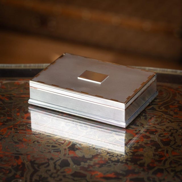 20th century english solid silver cigar box of rectangular form, finely engraved with linear detailing throughout. A rose...