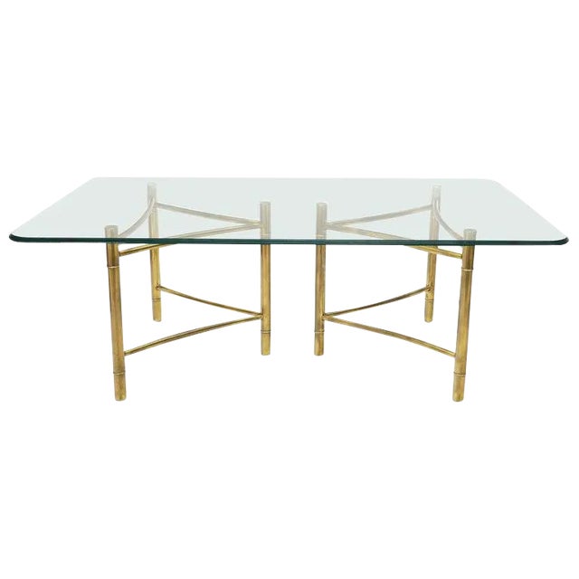 This is a mid to late 20th Century Large Mastercraft Brass Double Pedestal Dining table with a round edge glass top. This...