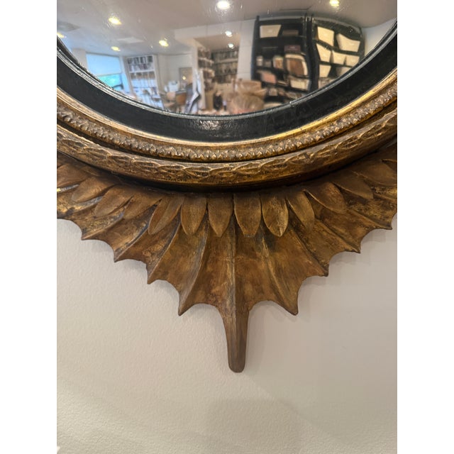 This is a handsome neoclassical convex “bull’s-eye” mirror, most closely associated with the English Regency period and...