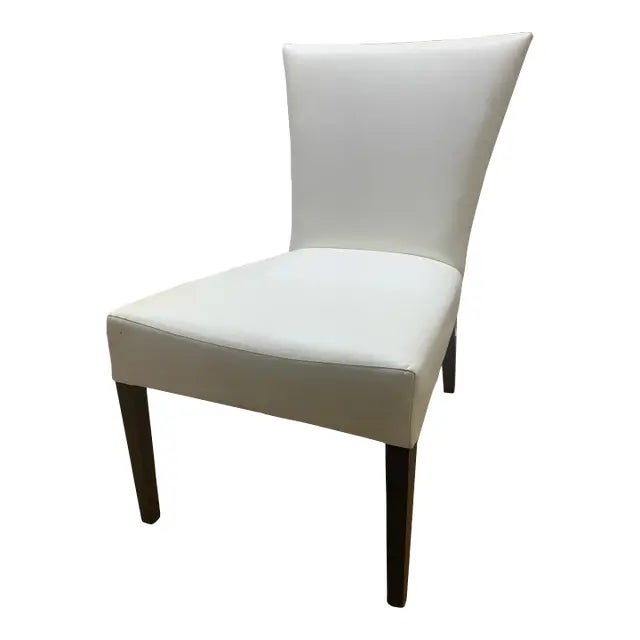 This is the Sevilla Chair Attributed to Brueton. It is upholstered in a cream fabric with dark maple legs.