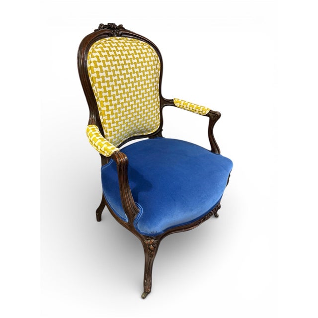 Elegant European-style carved wood armchair featuring a sculptural frame with scroll arms, cabriole legs, and a floral-...