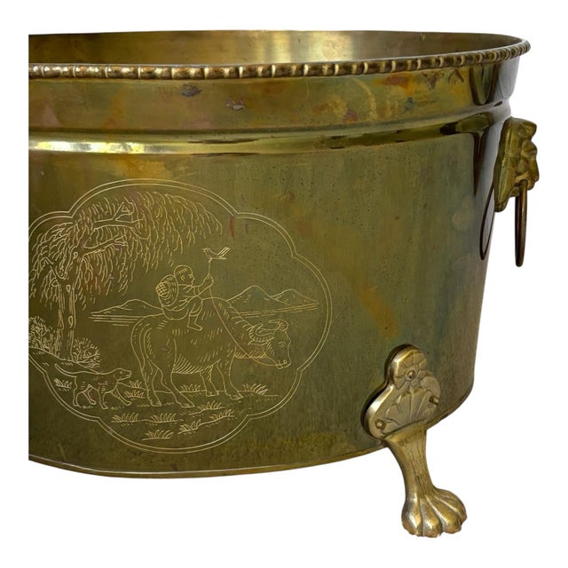 Vintage large oval cachepot featuring an intricately etched Asian-inspired scenic motifs, accented with decorative lion...