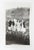Mid 20th century snapshot photograph of three woman being silly and striking a hitchhiker pose. Unframed, corner bumps.
