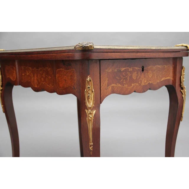 19th Century Kingwood and ormolu mounted card table, having a wonderful marquetry top profusely inlaid with floral...