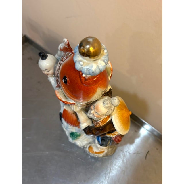 Vintage Chinese koi fish and fisherman/boy porcelain statue/sculpture. Excellent condition.