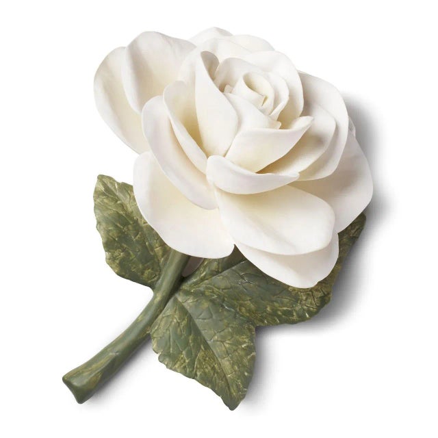 This hand-sculpted porcelain rose captures the fragile beauty of a flower atop verdant leaves. Meticulously painted in...
