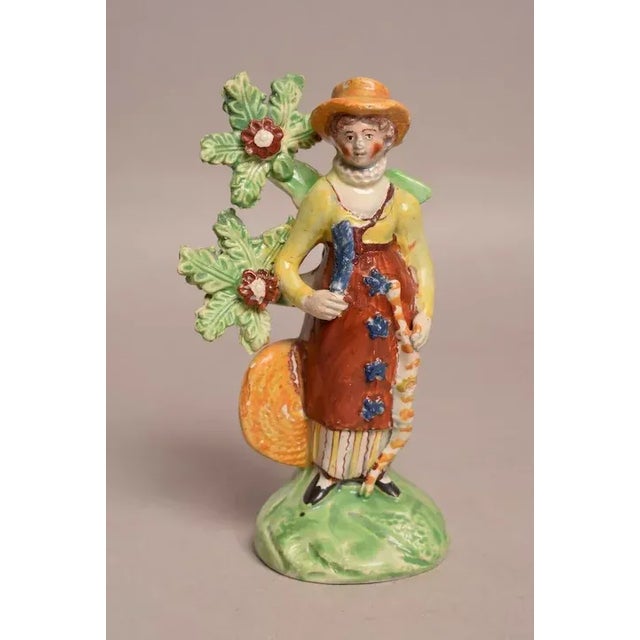 Antique early 19th century Georgian Staffordshire figure of a lady archer holding her bow and leaning on a tree bocage and...