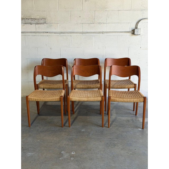 This set of 6 dining chairs features sculptural open backrests paired with tightly woven cord seating. The organic curves...