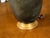 A vintage English bronze two-light table lamp from the mid 20th century with horse heads, gilded base and verdigris...