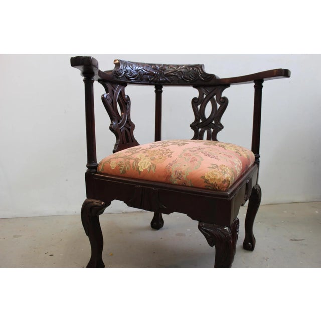 Chippendale style carved mahogany corner chair with upholstered seat and ball and claw feet. Dimensions: 30.5"H (17"SH) x...