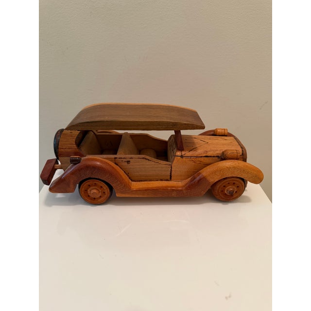 Charming vintage handcrafted wooden model car depicting an early Ford touring automobile. Made from contrasting woods with...