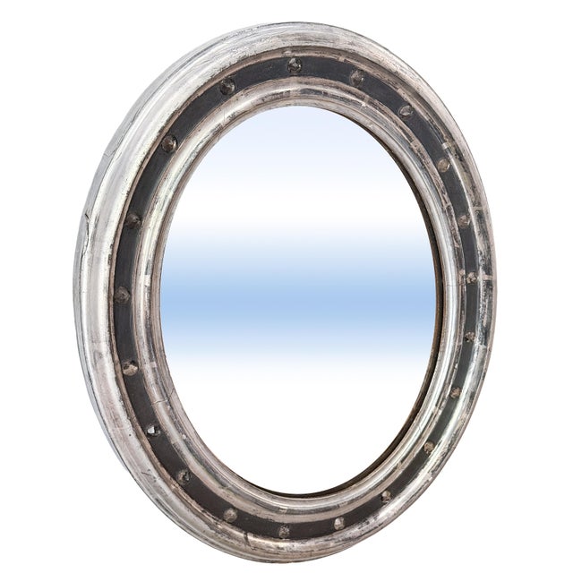 A fine Irish oval wall mirror from the 19th century, featuring a distinctive frame of silver parcel gilt alternating with...