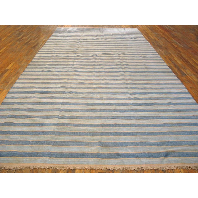 A virtually infinitely size adjustable gallery carpet format Indian bitonal flat-weave with full width stripes in ecru and...
