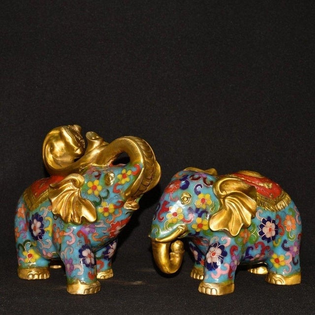 This charming pair of vintage cloisonne enamel elephant figurines brings a touch of traditional elegance to any interior....
