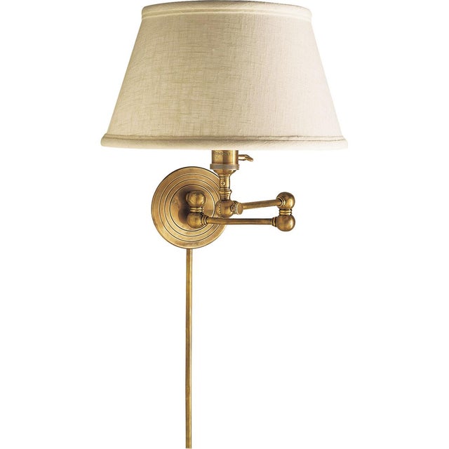 Boston Swing Arm in Hand-Rubbed Antique Brass with Linen Shade Designer: Chapman & Myers Height: 13" Extension: 18.5"...