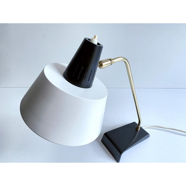 Kaiser Desk lamp, Modell 6813, 1960s, featuring a cantilivered black enameled cast iron base, brass stem and superimposed...