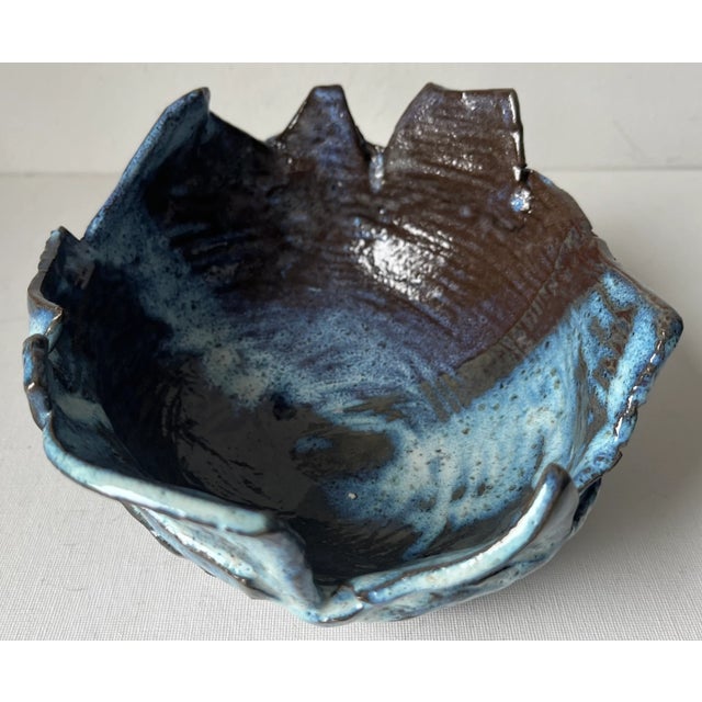 This fabulous Mid-Century Brutalist studio Art Pottery bowl features varying shades of Blue glazes on an asymmetrical form...